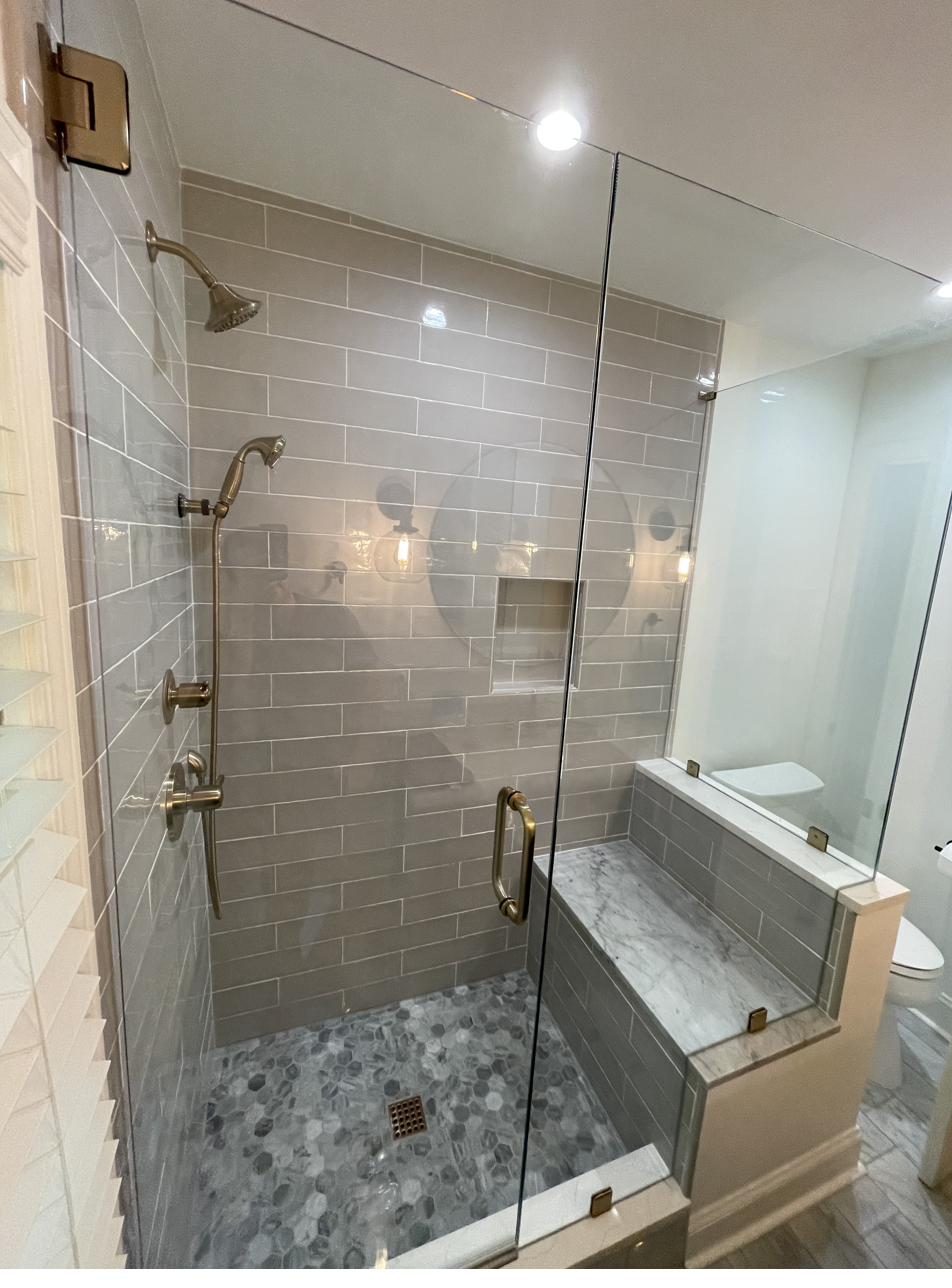 Bathroom — gray tile shower with marble bench